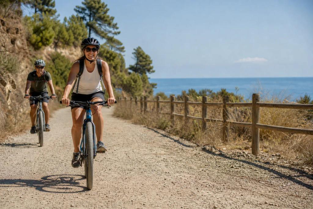 Cyclists on touring bikes riding along a flat, wide former railway path near Marbella